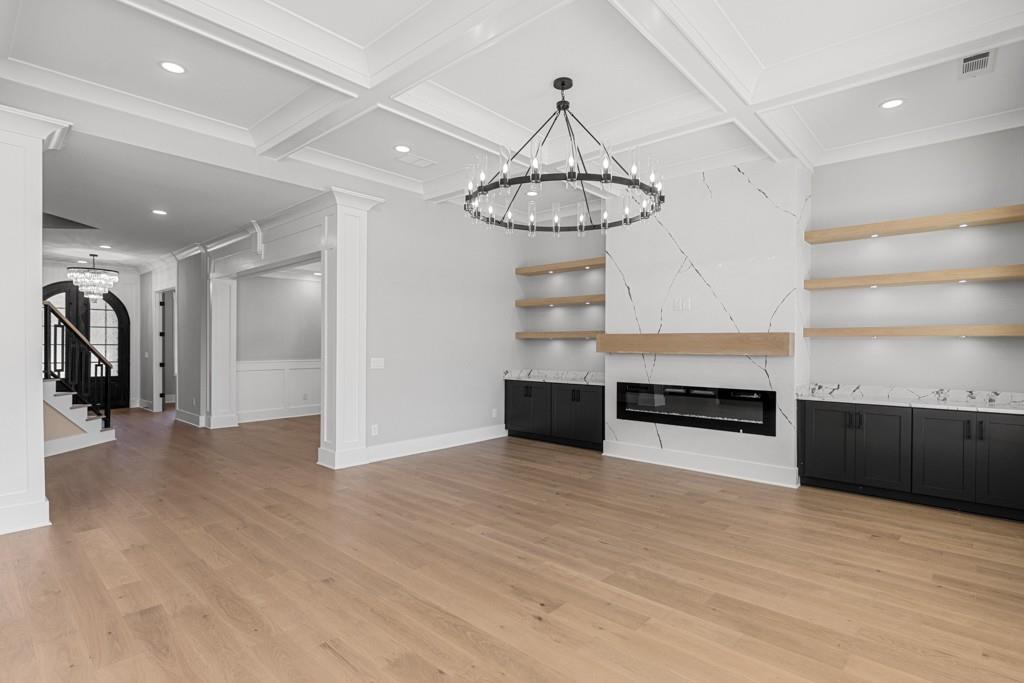2739 South Waterworks Road Buford, GA 30518 - Photo 14 of 62 a view of a room with wooden floor and a chandelier