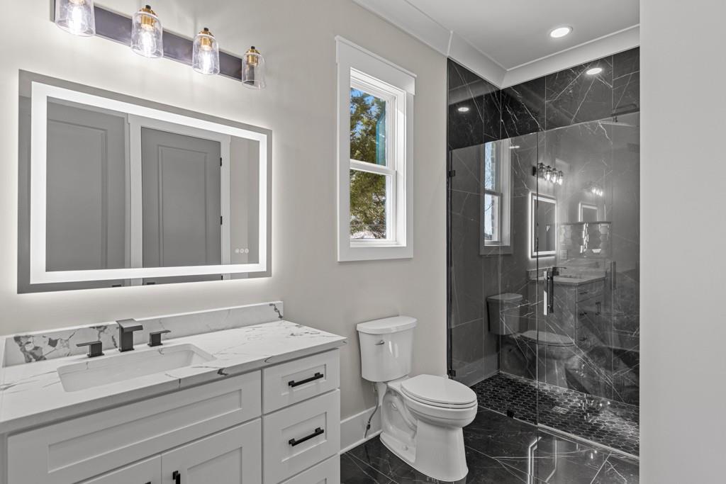 2739 South Waterworks Road Buford, GA 30518 - Photo 30 of 62 a bathroom with a granite countertop sink toilet and shower
