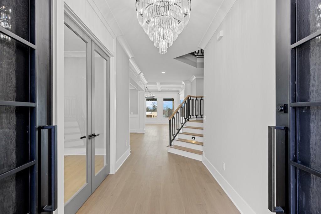 2739 South Waterworks Road Buford, GA 30518 - Photo 4 of 62 a view of a hallway with wooden floor and staircase