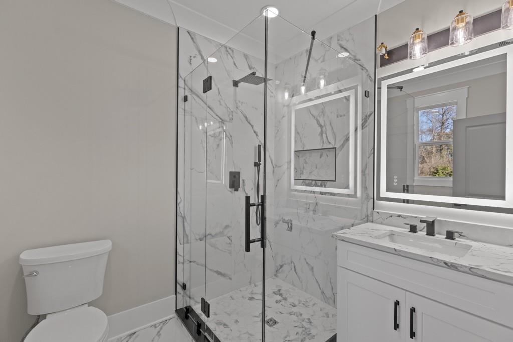 2739 South Waterworks Road Buford, GA 30518 - Photo 41 of 62 a bathroom with a granite countertop sink toilet and shower