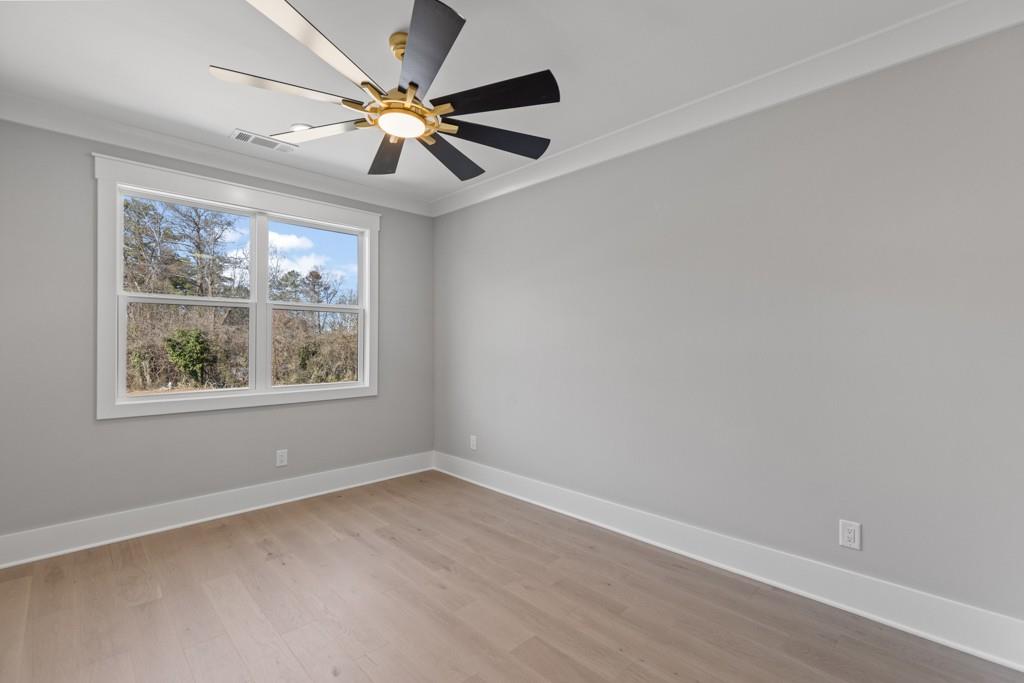 2739 South Waterworks Road Buford, GA 30518 - Photo 42 of 62 an empty room with a window and a fan