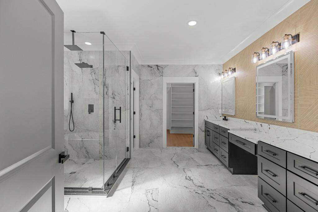 2739 South Waterworks Road Buford, GA 30518 - Photo 52 of 62 a bathroom with a granite countertop sink mirror shower and bathtub