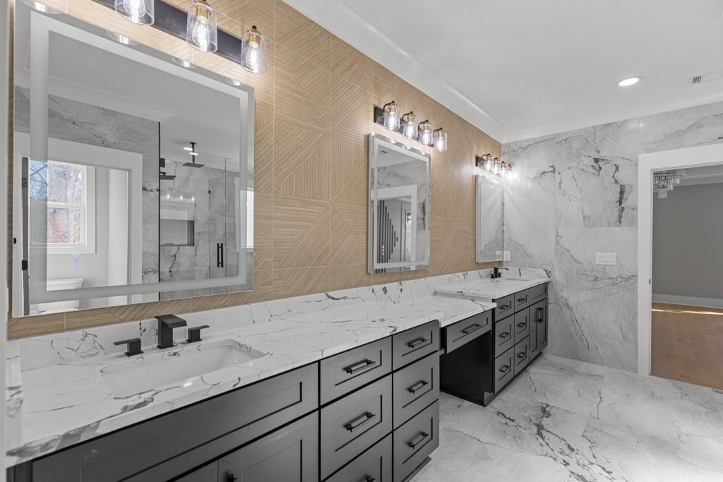 2739 South Waterworks Road Buford, GA 30518 - Photo 54 of 62 a bathroom with a granite countertop double vanity sink and mirror