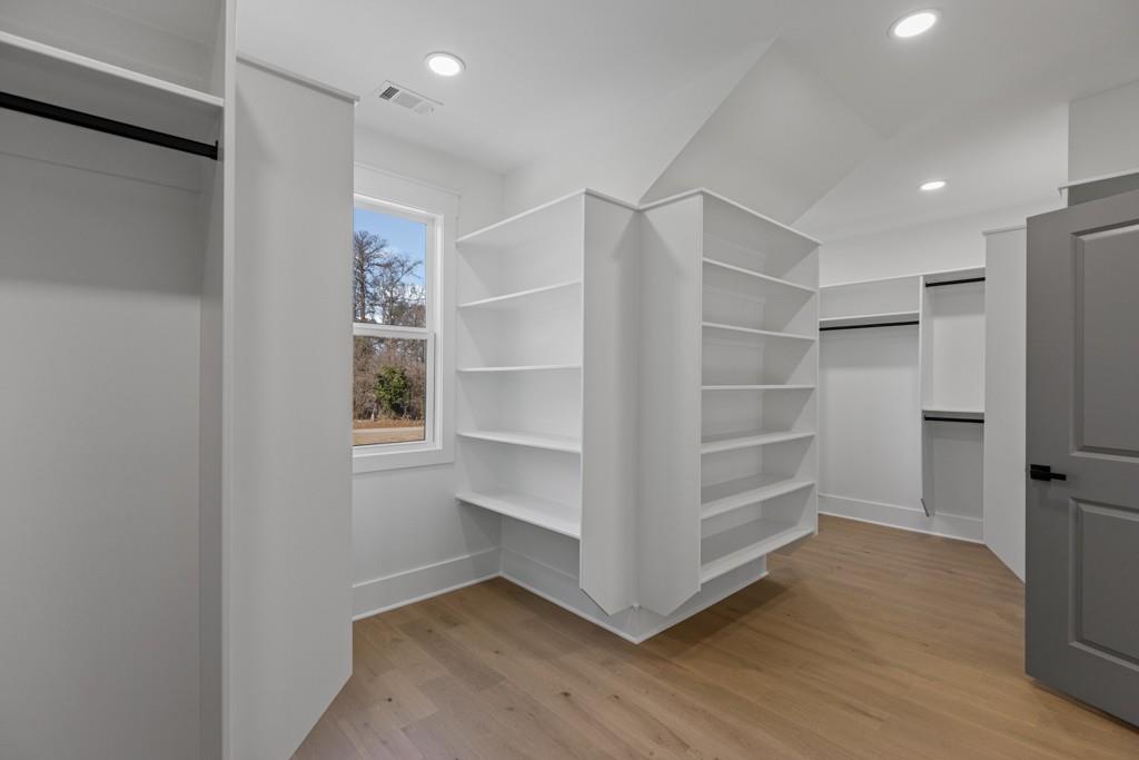 2739 South Waterworks Road Buford, GA 30518 - Photo 55 of 62 a view of walk in closet with empty racks