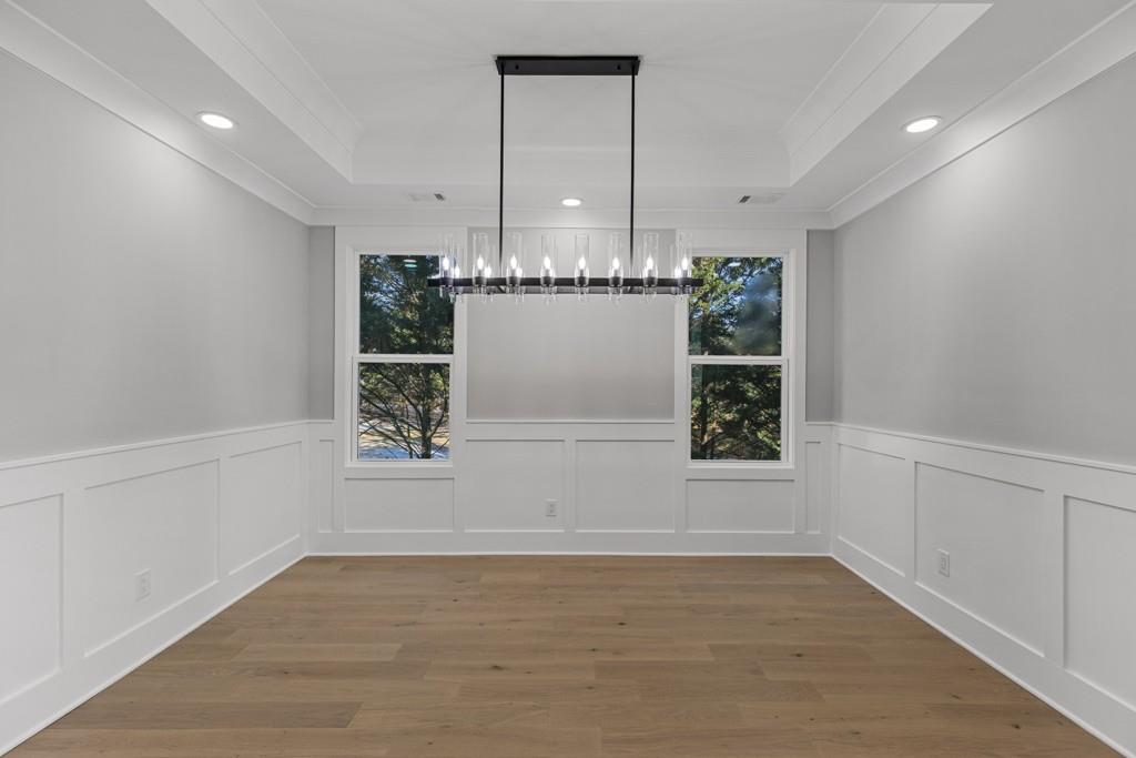 2739 South Waterworks Road Buford, GA 30518 - Photo 9 of 62 an empty room with wooden floor and windows