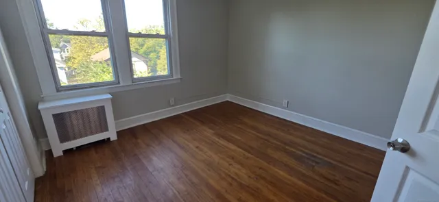 wooden floor in an empty room with a window