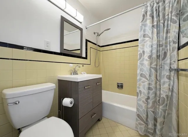 a bathroom with a toilet a sink and bathtub