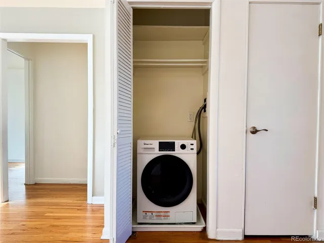 a view of a bedroom with washer and dryer