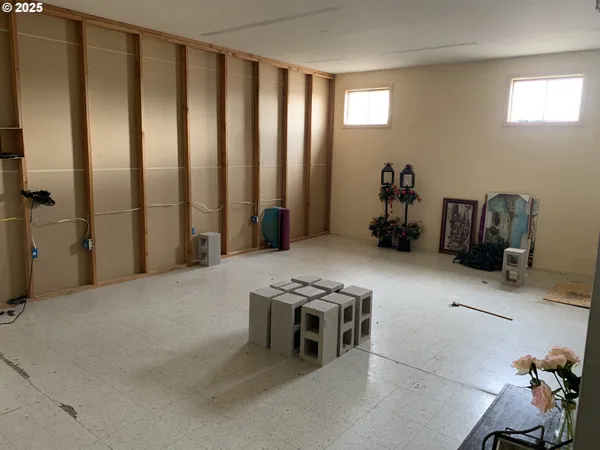 a view of a hallway with wooden floor and a cabinet