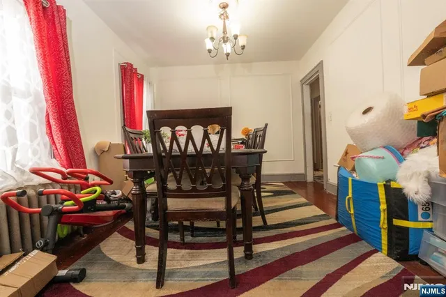 a view of a dining room with furniture and chandelier