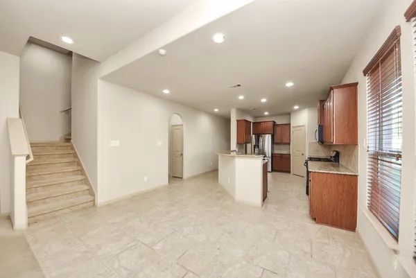a view of kitchen with furniture and refrigerator