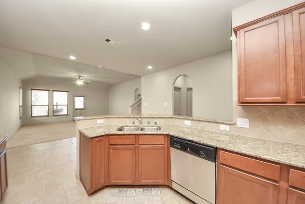 a kitchen with a sink stove and cabinets