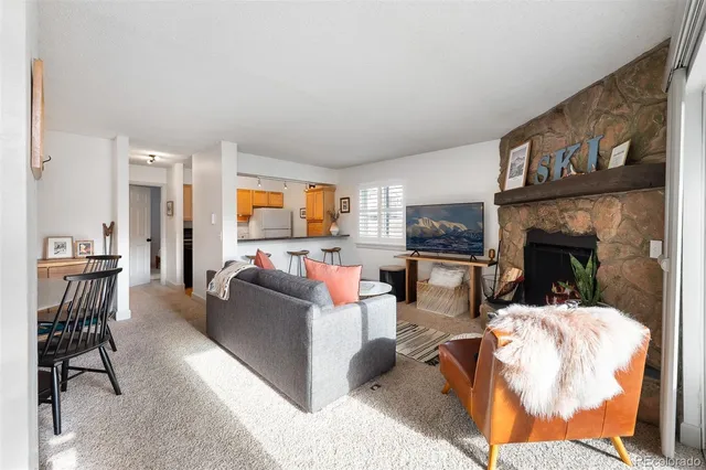 a living room with fireplace furniture and a flat screen tv