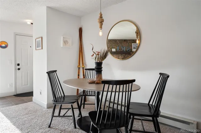 a view of a dining room with furniture and a mirror