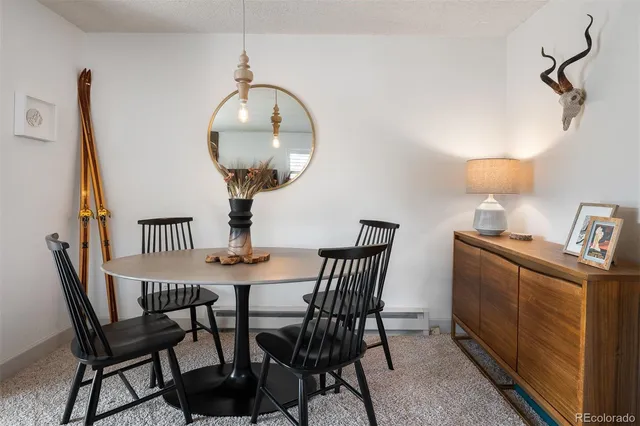 a dining room with furniture and wooden floor