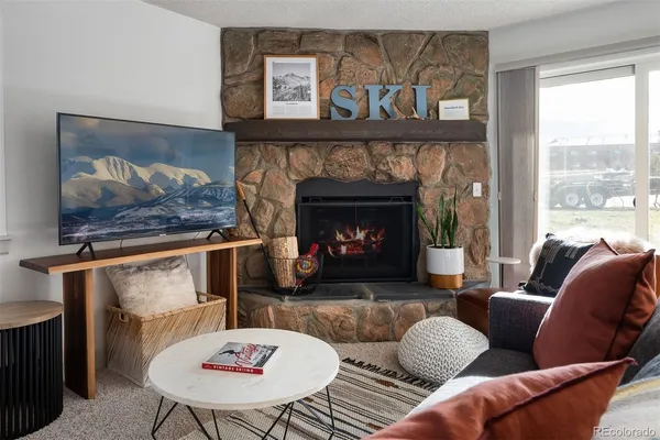 a living room with furniture and a fireplace