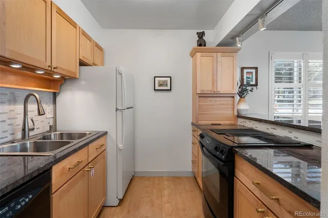a kitchen that has a sink and a stove