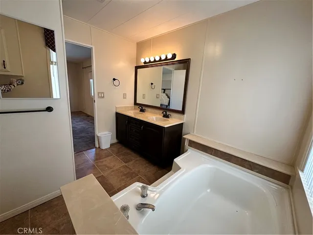 a bathroom with a sink vanity and mirror