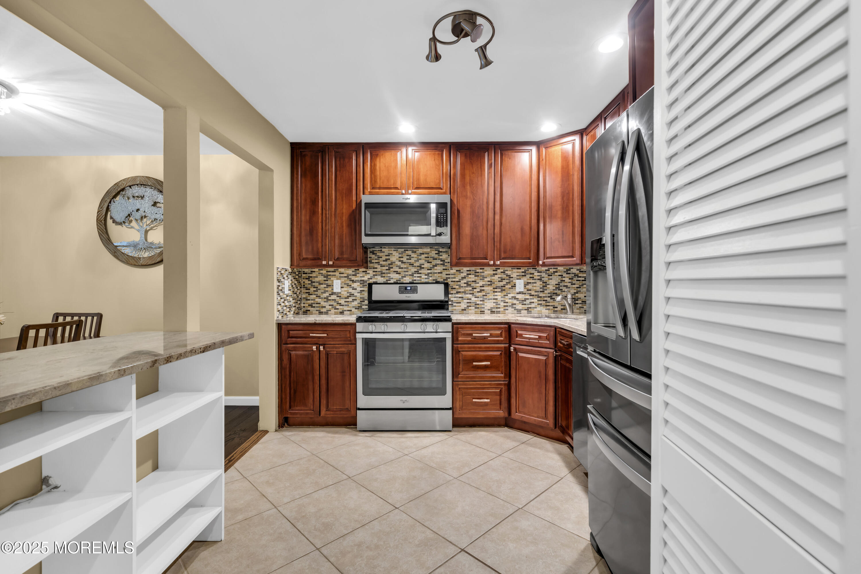 512 Harding Road, Unit 6 Freehold, NJ 07728 - Photo 20 of 36 a kitchen with stainless steel appliances granite countertop a stove and a sink