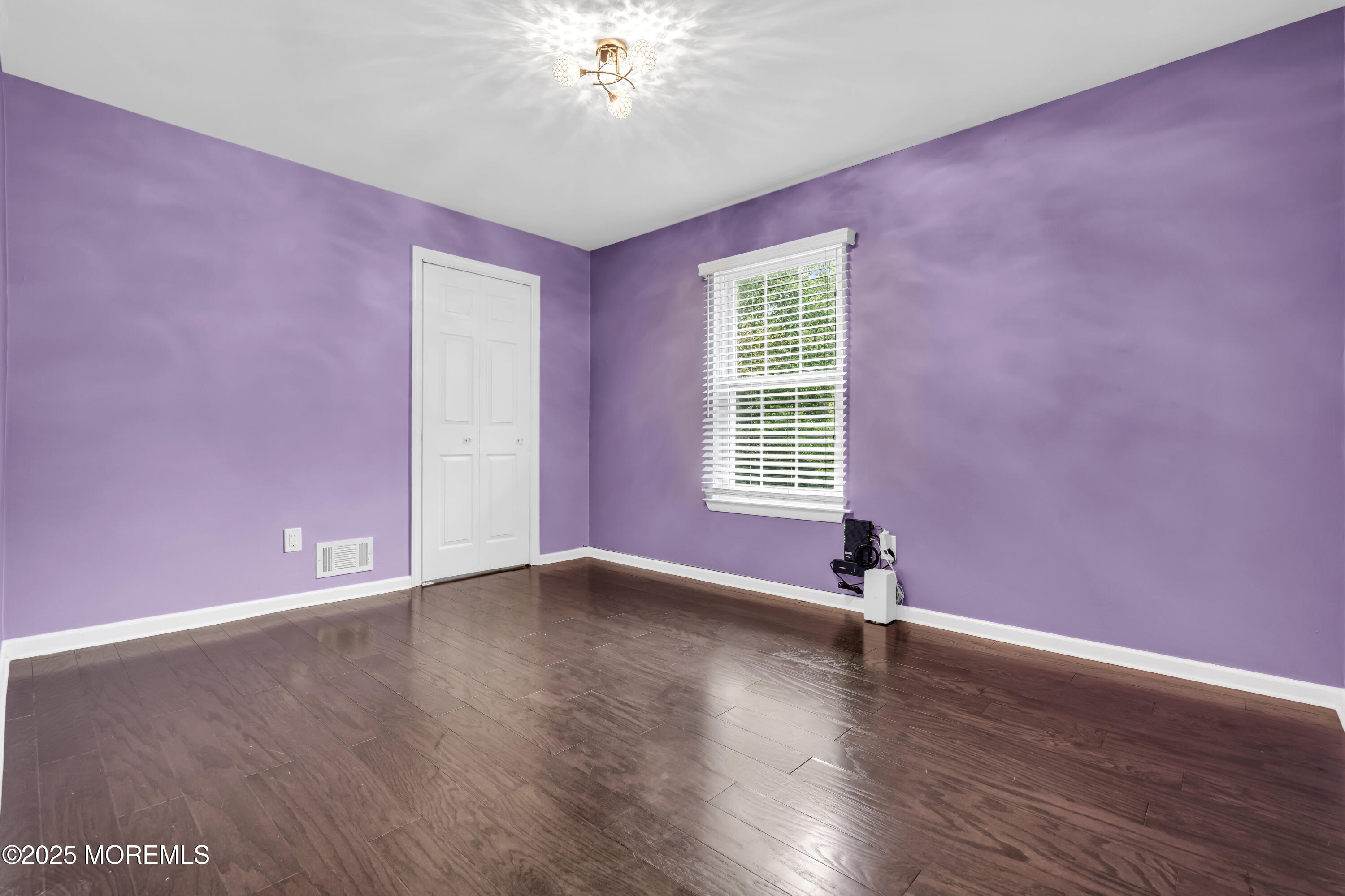 512 Harding Road, Unit 6 Freehold, NJ 07728 - Photo 33 of 36 a view of an empty room with a window and wooden floor