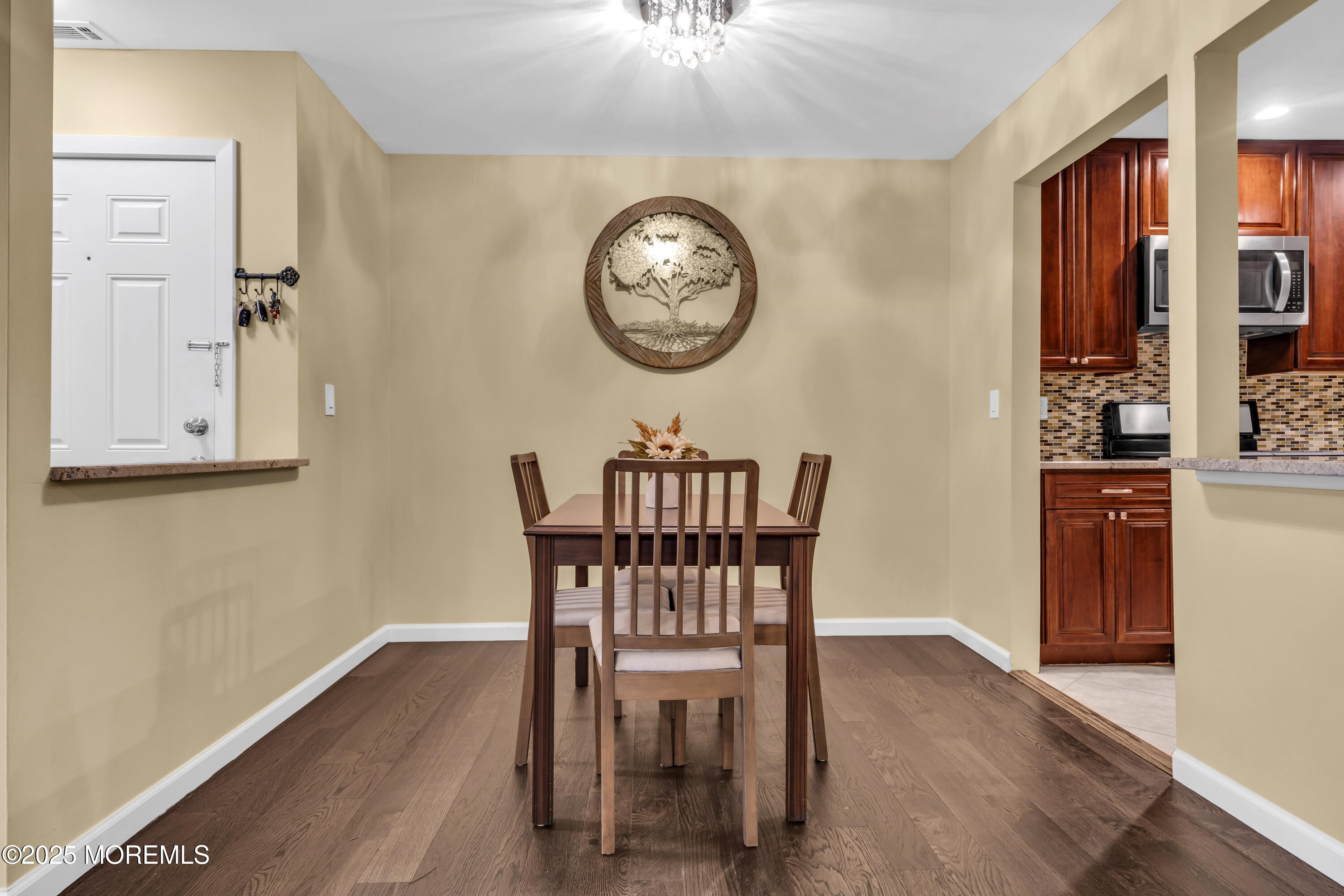 512 Harding Road, Unit 6 Freehold, NJ 07728 - Photo 5 of 36 a view of a dining room with furniture and wooden floor