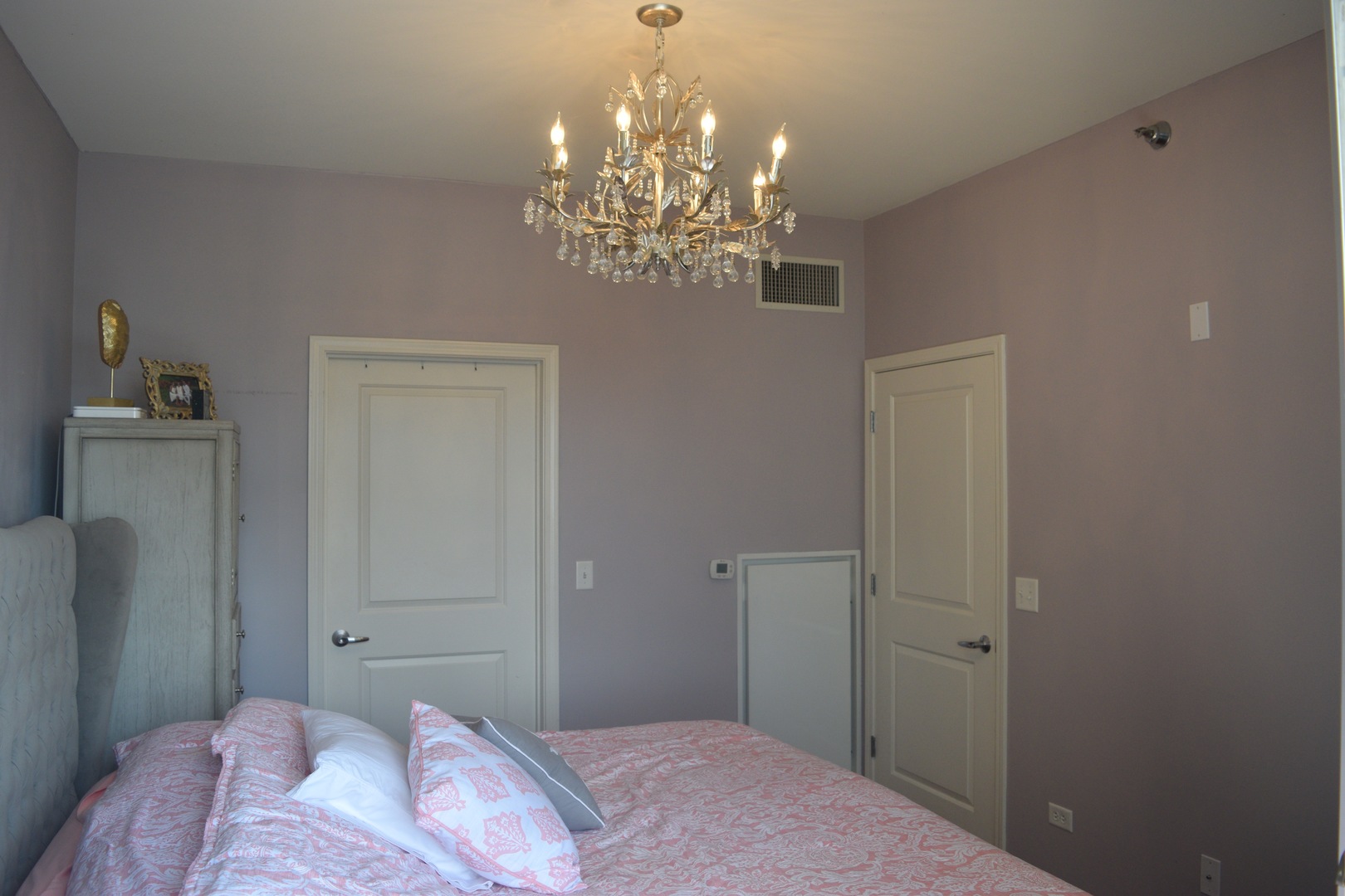 1400 South Michigan Avenue, Unit 2108 Chicago, IL 60605 - Photo 5 of 14 a bedroom with a bed and chandelier