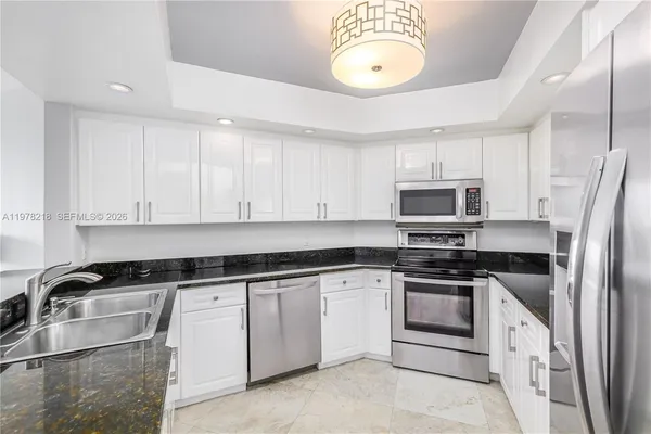 a kitchen with a sink and refrigerator