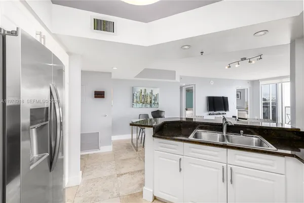 a utility room with sink dryer and washer