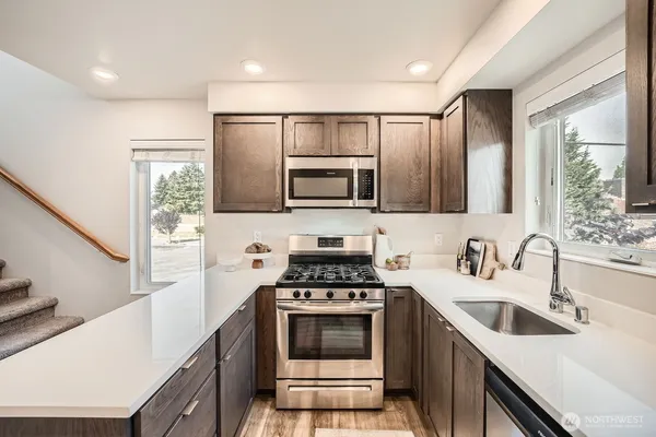 a kitchen with a sink cabinets and stainless steel appliances