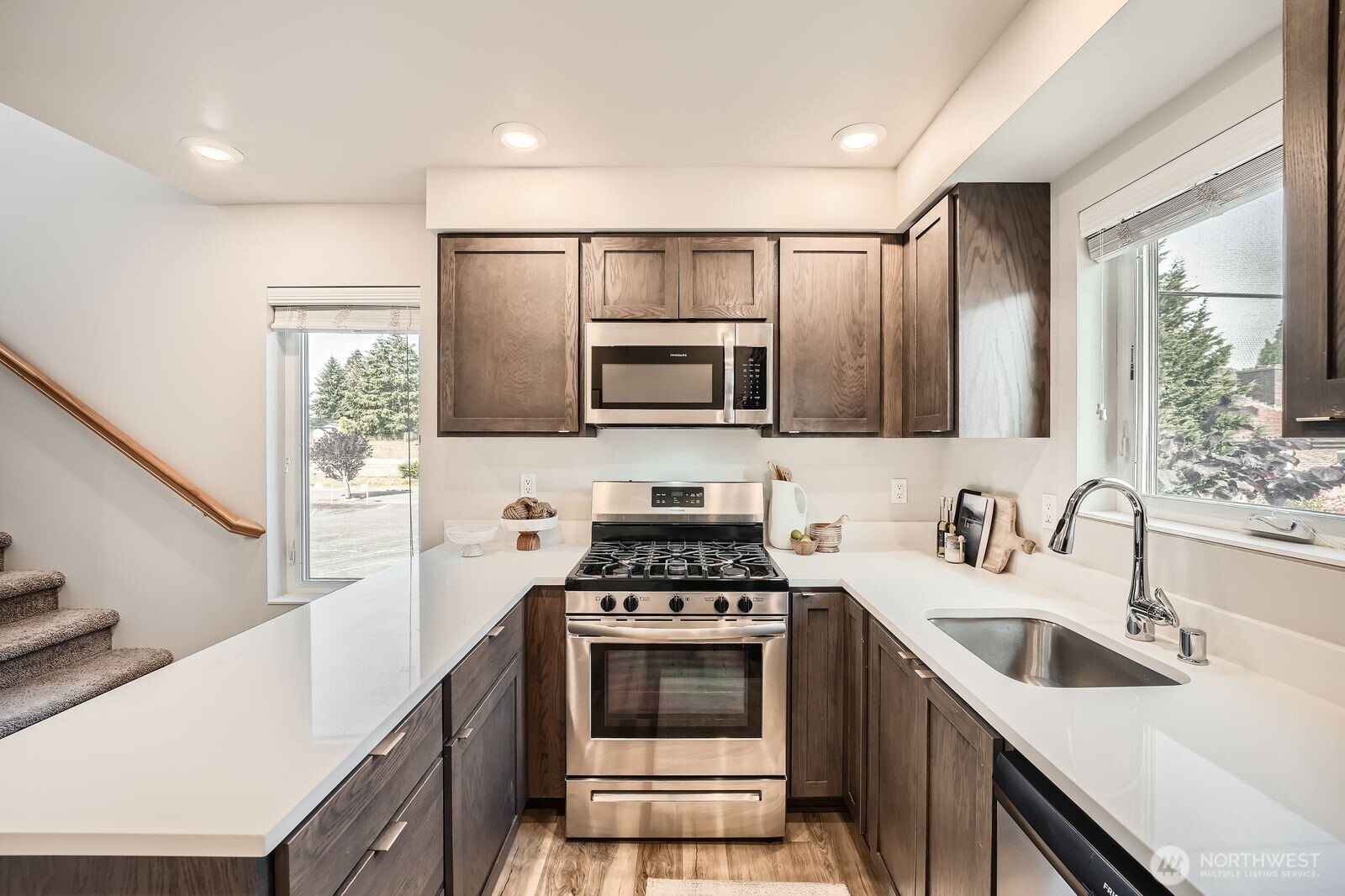 1803 Southwest 96th Lane Seattle, WA 98106 - Photo 12 of 33 a kitchen with a sink cabinets and stainless steel appliances