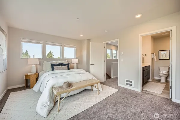 a bedroom with a bed and a large mirror
