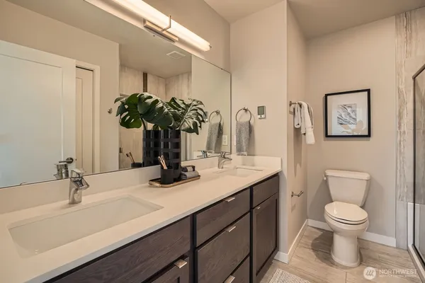 a bathroom with a sink a toilet and mirror