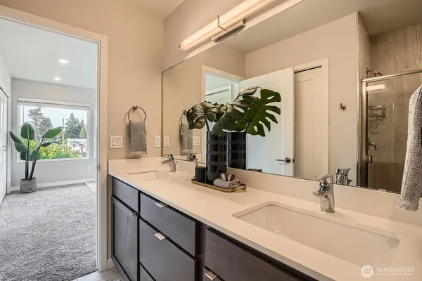 a bathroom with a double vanity sink and a mirror