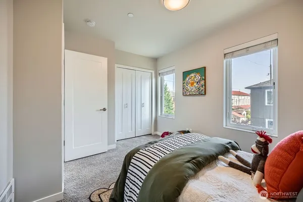 a bed room with a bed and a window