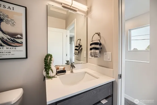 a bathroom with a sink vanity and a mirror