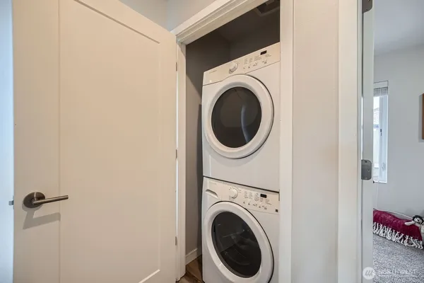 a view of a hallway with washer and dryer