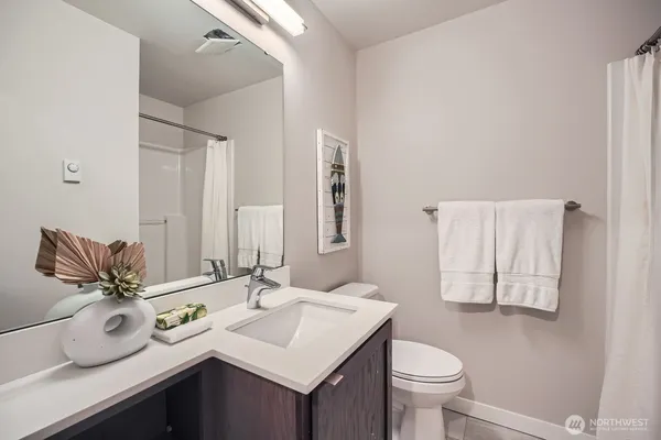a bathroom with a sink toilet and mirror