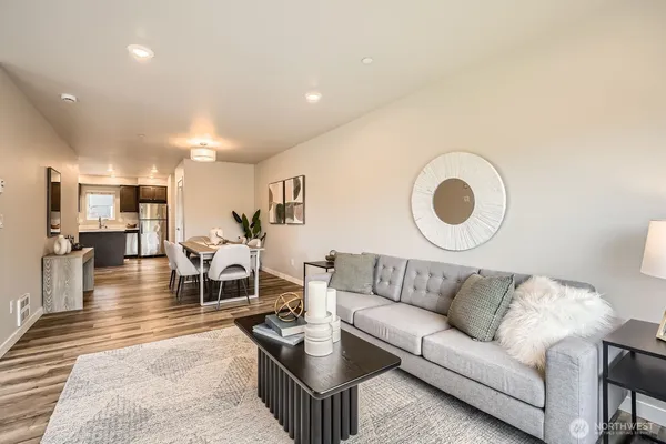 a living room with furniture and kitchen view