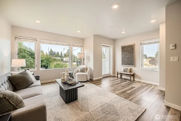 a living room with furniture and large windows