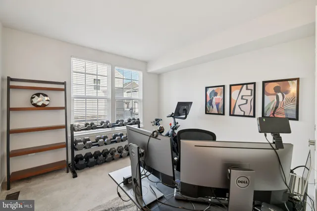 a room with gym equipment and a window