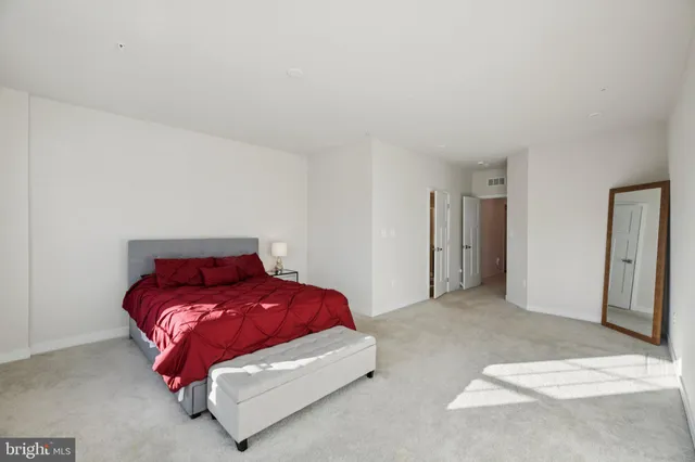 a bedroom with a bed and a night stand