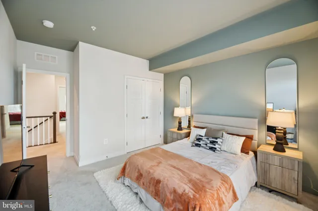 a bedroom with a bed and a mirror