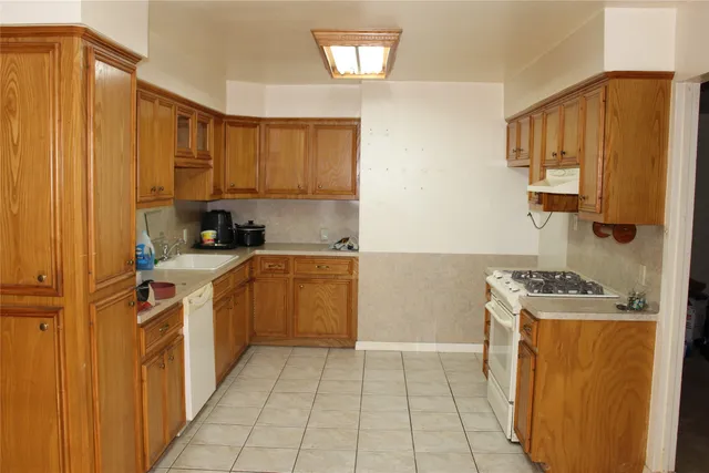a kitchen with a sink stove and cabinets