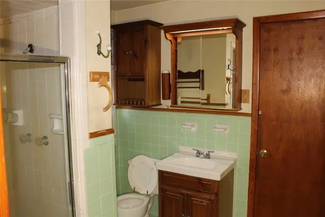 a bathroom with a sink toilet and shower