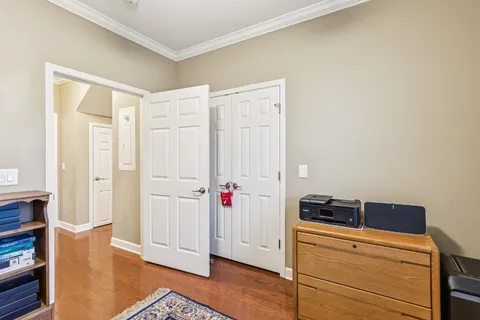 a view of a storage and utility room with wooden floor