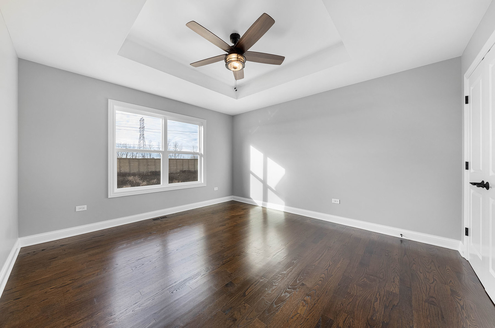 2004 Oldfield Road Darien, IL 60561 - Photo 17 of 40 an empty room with wooden floor chandelier fan and windows