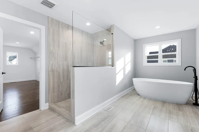 a bathroom with a bathtub and a shower