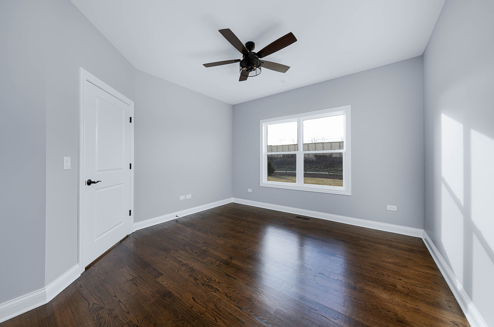 2004 Oldfield Road Darien, IL 60561 - Photo 37 of 40 an empty room with wooden floor a ceiling fan and windows