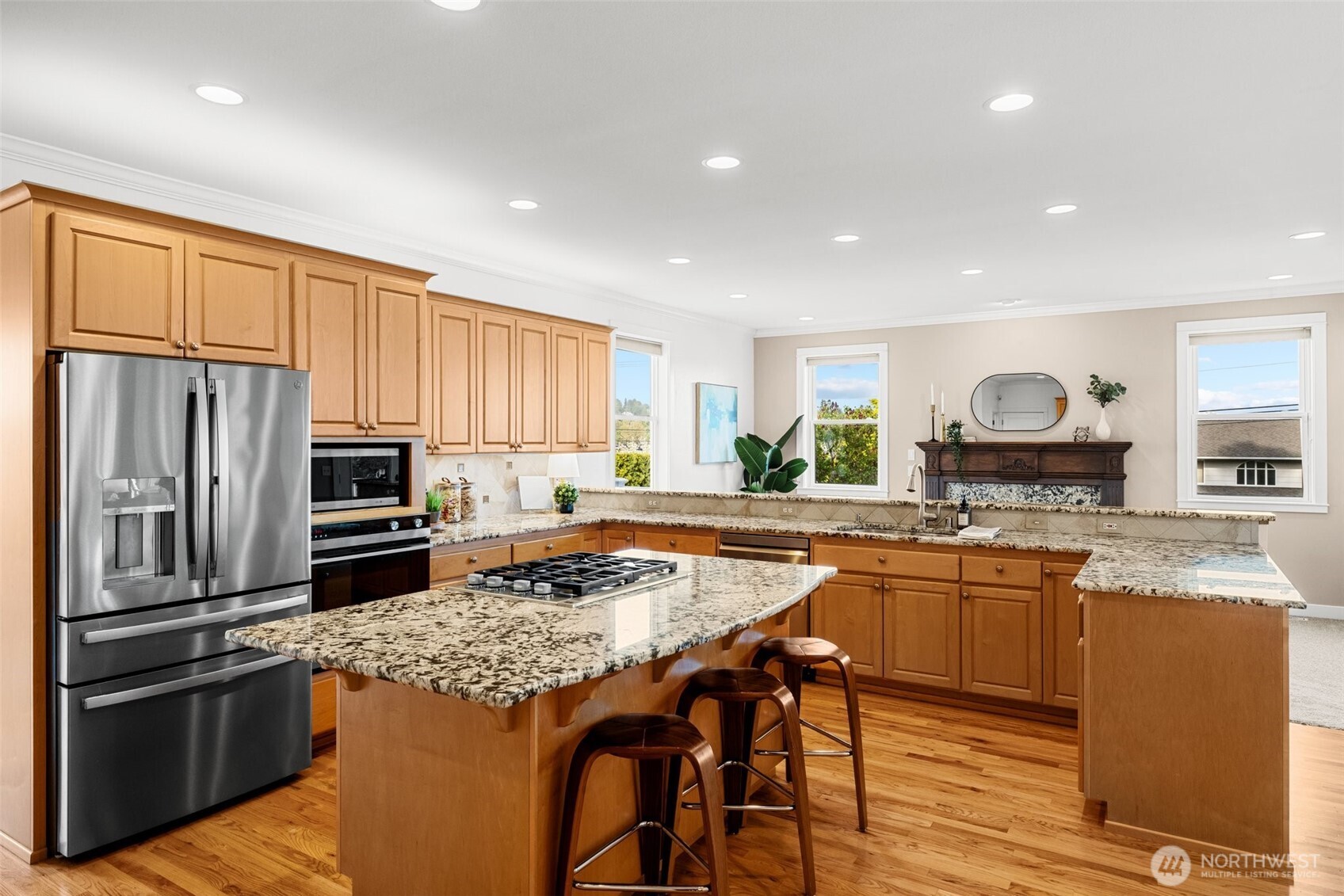 1802 Vernon Road Lake Stevens, WA 98258 - Photo 12 of 40 a kitchen with granite countertop kitchen island stainless steel appliances a stove a sink a refrigerator and cabinets
