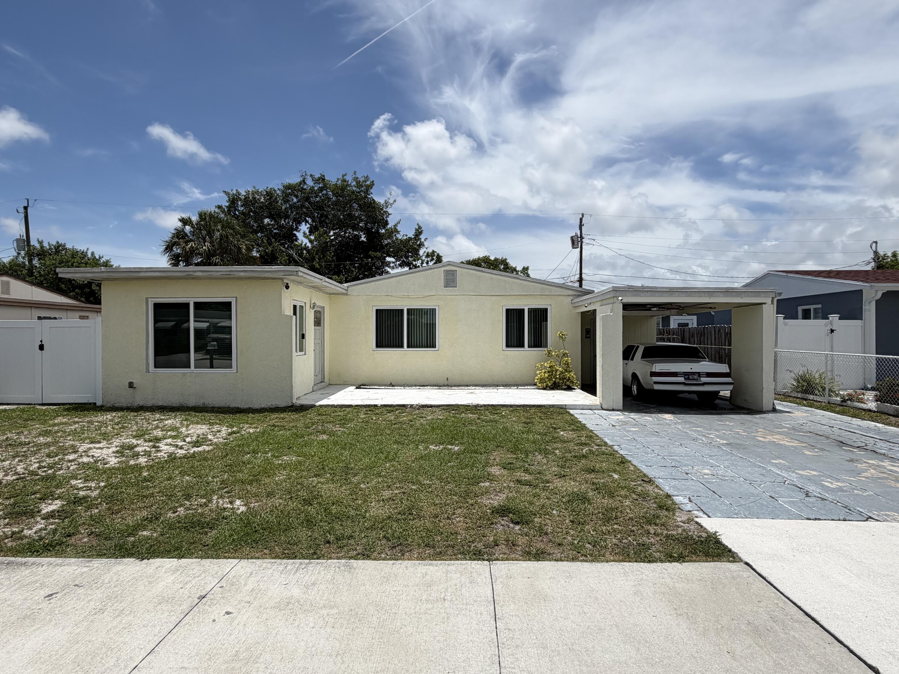 2016 Kenwood Road West Palm Beach, FL 33409 - Photo 1 of 4 a house view with a garden space